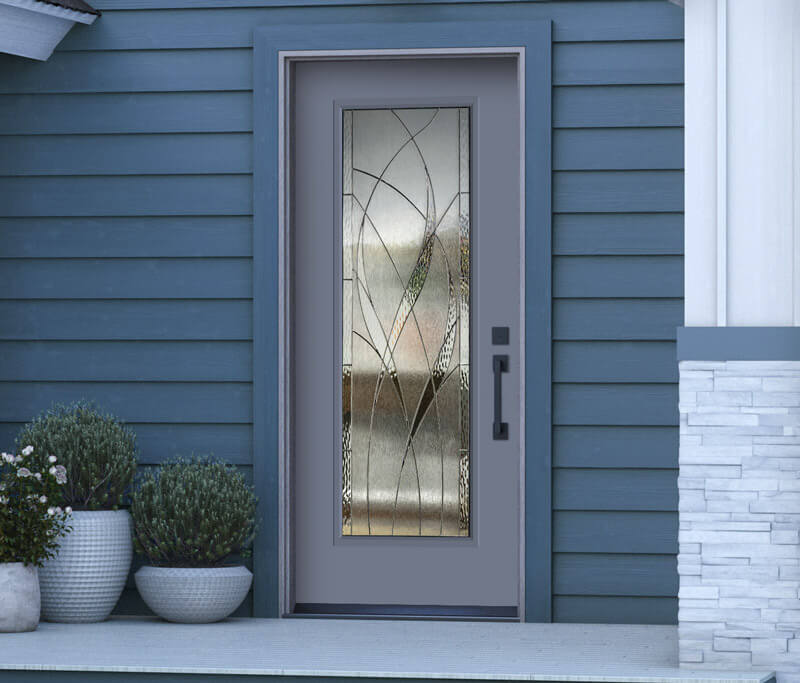 A modern blue front entry door with a decorative glass panel showcasing abstract patterns. The exterior wall boasts blue horizontal siding, with two potted plants featuring spherical greenery flanking the door, and a glimpse of stone facade visible on the right.