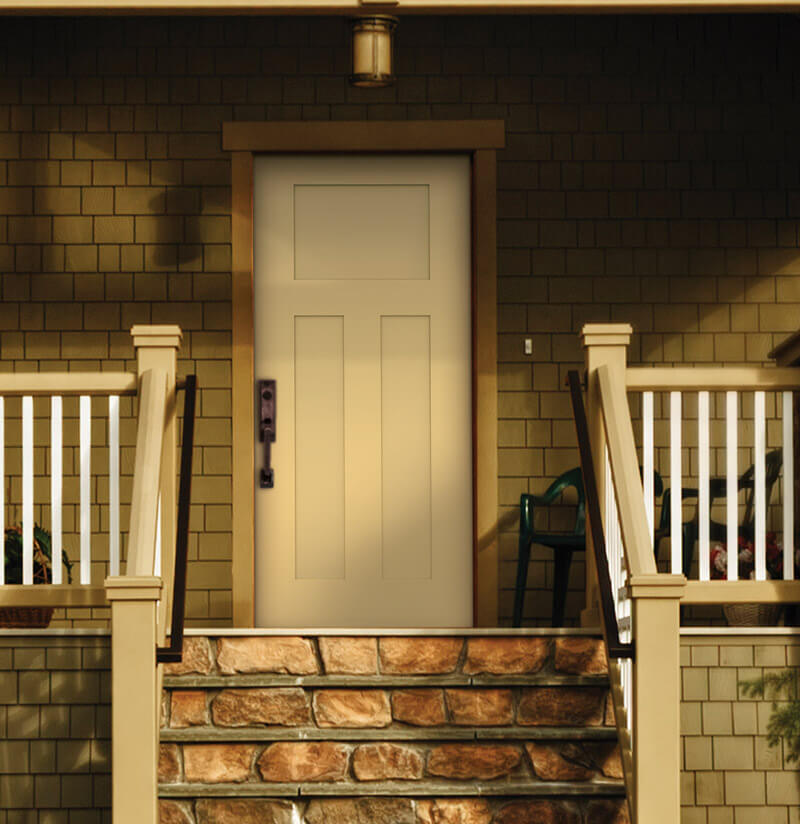 A solid fiberglass entry door in beige, featuring a black handle, is centered on a porch with stone steps and white railings. The house boasts brown shingle siding. A chair rests on the porch to the right of the door, while a light fixture elegantly hangs above.