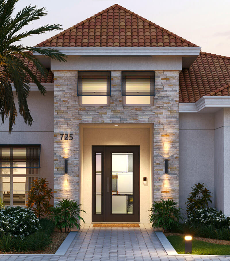 Modern house exterior featuring an impact-resistant dark wooden double door with frosted glass panels. The façade boasts light stone accents, two windows above the door, and is flanked by small shrubs and wall-mounted lights, all under a classic red-tiled roof.