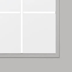 A close-up of a door with four panes in a white frame, reflecting the sleek simplicity reminiscent of aluminum door design. The background is a light gray wall, complementing the windows minimalistic charm.