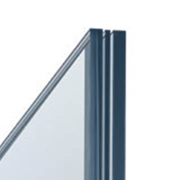 Close-up of the edge of an insulated glass unit for windows, showcasing two layers of glass separated by a narrow gap. The slightly tinted panes are framed by a dark, smooth metal edge. The background is plain white.